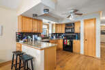 This stunning kitchen boasts beautiful wooden cabinetry and a spacious layout, perfect for both cooking and entertaining.