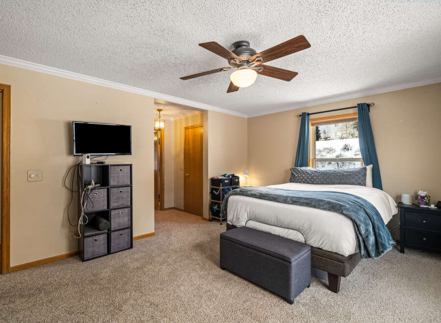 This inviting bedroom features a cozy atmosphere with neutral tones and ample natural light.