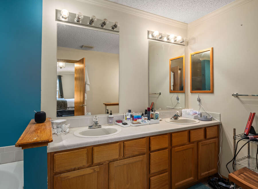 This inviting bathroom features a double vanity with ample counter space, perfect for getting ready in the morning.