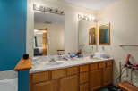 This inviting bathroom features a double vanity with ample counter space, perfect for getting ready in the morning.