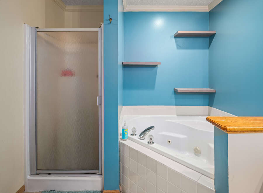 This bathroom features a luxurious jacuzzi tub, perfect for relaxation.