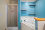 This bathroom features a luxurious jacuzzi tub, perfect for relaxation.