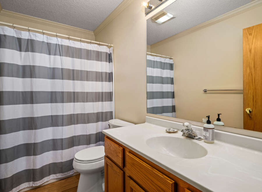 This bathroom features a clean and modern design with a white countertop and a stylish sink.