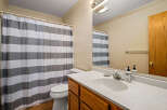 This bathroom features a clean and modern design with a white countertop and a stylish sink.