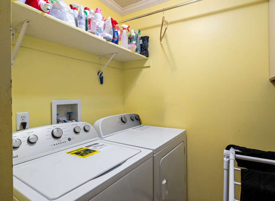 Discover the convenience of this well-equipped laundry room, featuring a modern washer and dryer set.