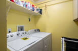 Discover the convenience of this well-equipped laundry room, featuring a modern washer and dryer set.