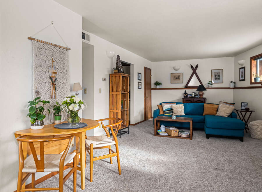 This inviting living space features a cozy seating area and a stylish dining nook, perfect for both relaxation and entertaining.