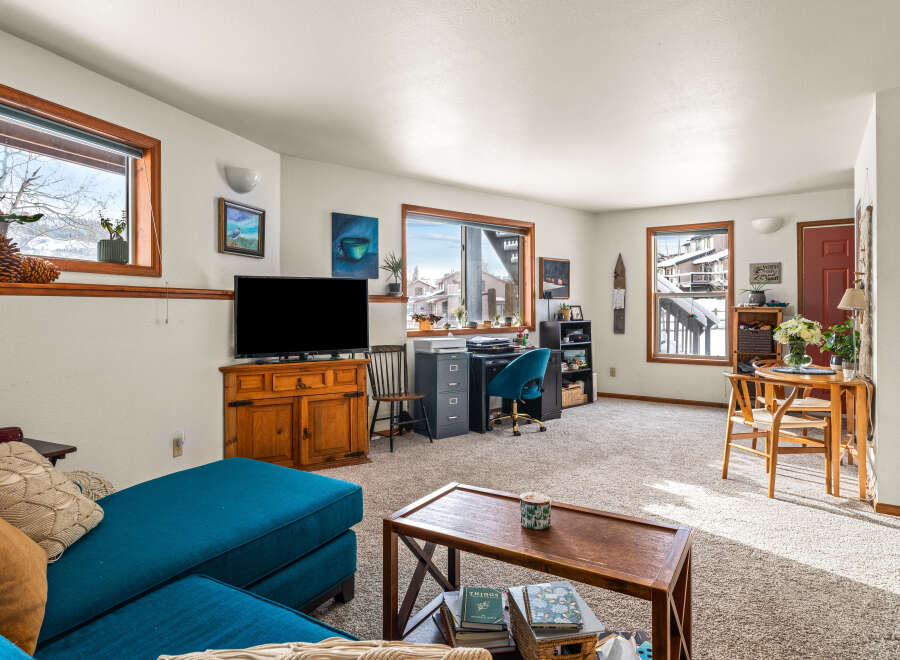 This cozy living space features a comfortable teal sectional sofa, perfect for relaxing.