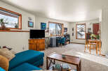 This cozy living space features a comfortable teal sectional sofa, perfect for relaxing.