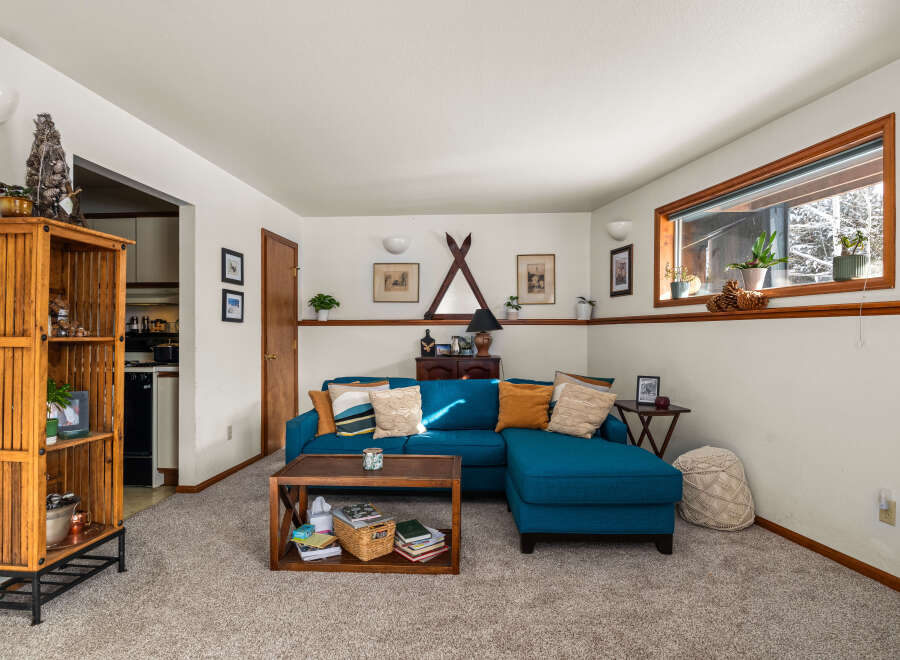 This cozy living room features a stylish teal sectional sofa, perfect for relaxing and entertaining.