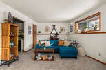 This cozy living room features a stylish teal sectional sofa, perfect for relaxing and entertaining.