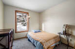 This cozy bedroom offers a tranquil retreat with its inviting ambiance and natural light.