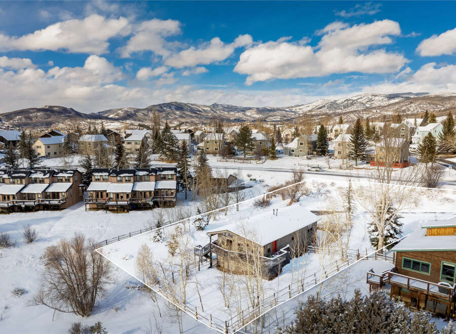 Nestled in a serene winter landscape, this charming property offers a cozy retreat.