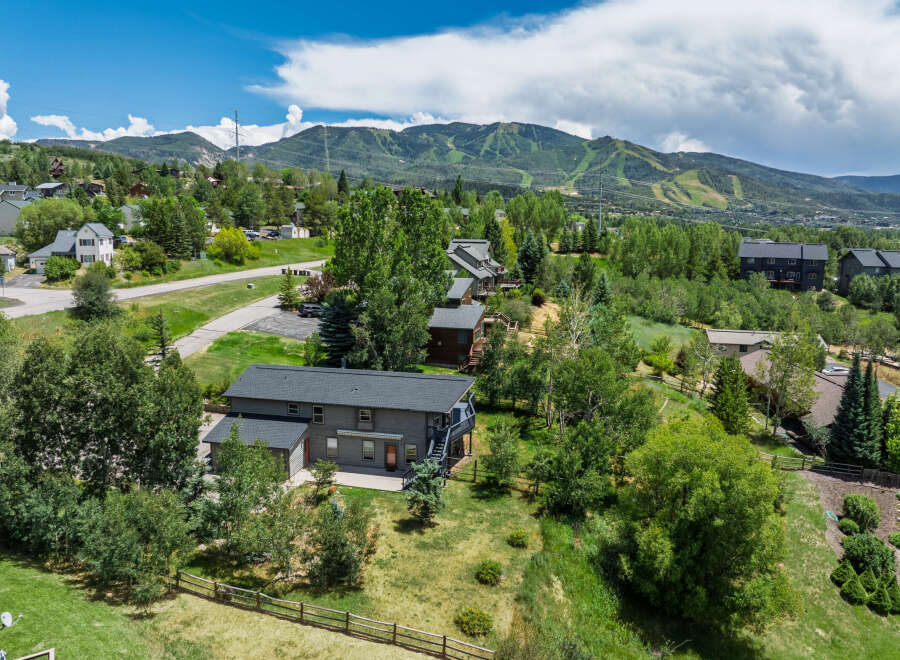 Nestled amidst lush greenery and offering stunning mountain views, this property boasts a spacious multi-level home perfect for family living.