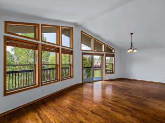 Experience breathtaking mountain views from this stunning living room, featuring a wall of large windows that flood the space with natural light.