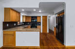 Discover this charming kitchen featuring warm oak cabinetry and granite countertops, perfect for any home chef.