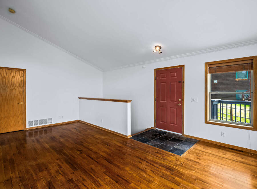 Step into this inviting entryway featuring gleaming hardwood floors that extend throughout the space.