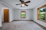 Step into this spacious room, featuring a warm wooden door and a large window offering picturesque views of the outdoors.