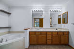 This spacious bathroom features a large soaking tub and a double vanity with ample counter space.