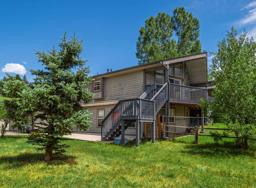 Discover this charming home featuring a multi-level deck perfect for outdoor entertaining and enjoying the serene surroundings.