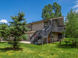 Discover this charming home featuring a multi-level deck perfect for outdoor entertaining and enjoying the serene surroundings.