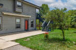 Discover this charming property featuring a welcoming red door and an exterior awning for added comfort.