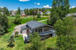 Nestled amidst lush greenery and mature trees, this charming home offers a serene mountain retreat.