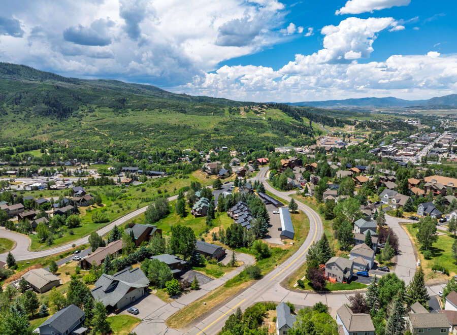 Discover this stunning mountain town home, nestled amidst lush greenery and offering breathtaking panoramic views.
