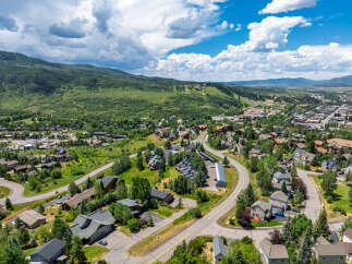 Discover this stunning mountain town home, nestled amidst lush greenery and offering breathtaking panoramic views.