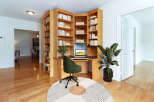 This stunning property features a custom-built home office with a built-in desk and shelving, perfect for remote work or study.