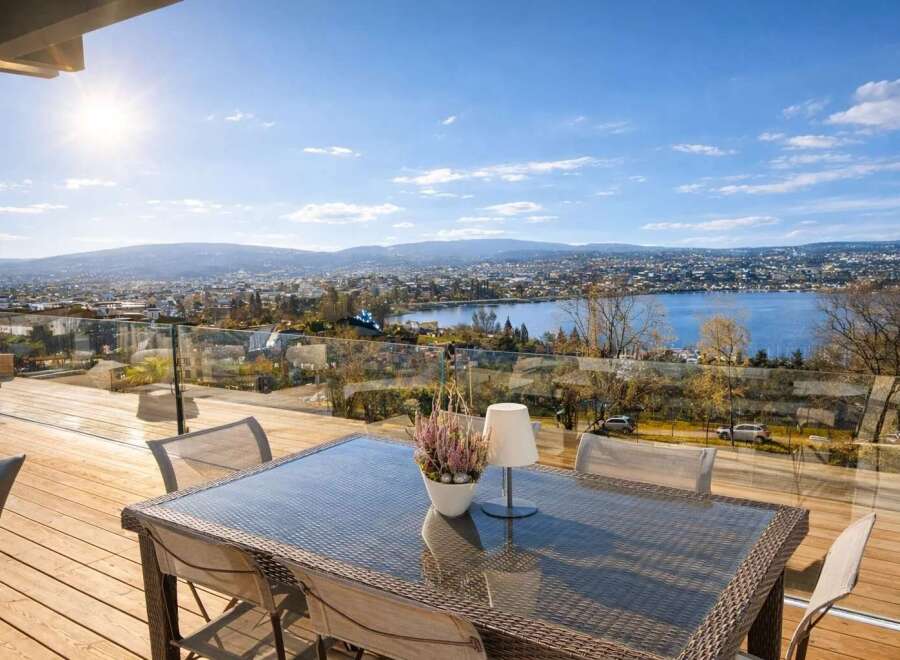 Enjoy breathtaking panoramic views from this stunning property! This home features a spacious deck with a glass railing, perfect for entertaining or relaxing.