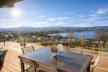 Enjoy breathtaking panoramic views from this stunning property! This home features a spacious deck with a glass railing, perfect for entertaining or relaxing.