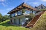 This stunning modern home boasts a sleek design with expansive glass windows, offering breathtaking views and abundant natural light.