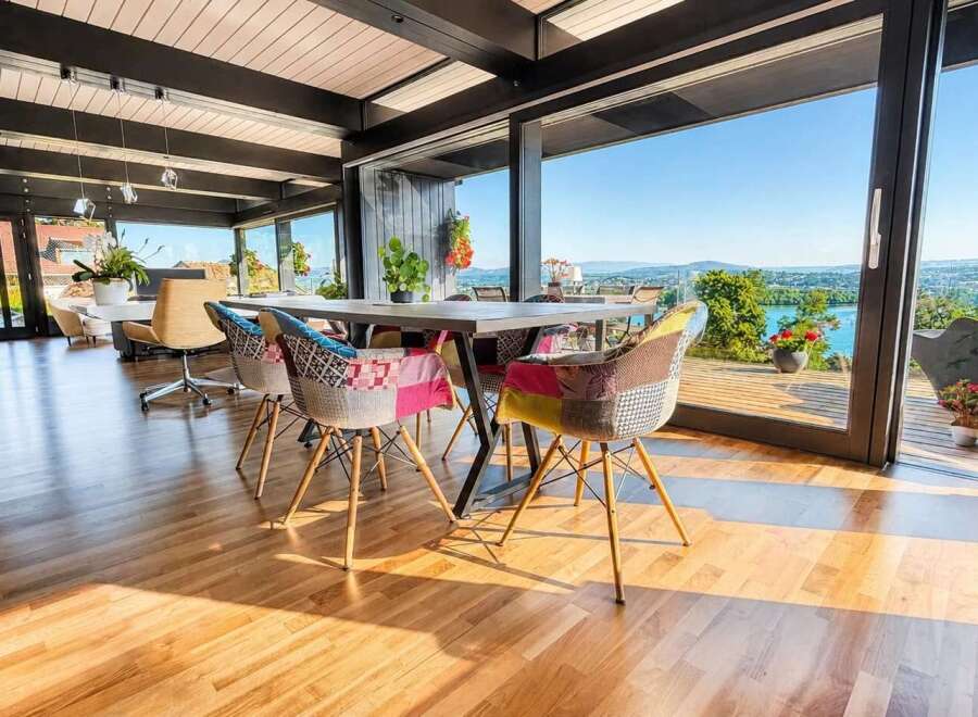 Experience breathtaking panoramic views from this stunning dining area, featuring floor-to-ceiling windows that seamlessly blend indoor and outdoor living.