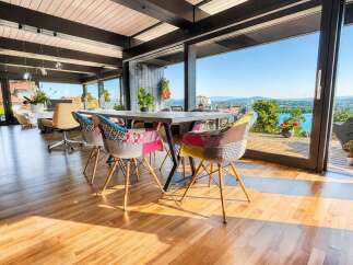 Experience breathtaking panoramic views from this stunning dining area, featuring floor-to-ceiling windows that seamlessly blend indoor and outdoor living.
