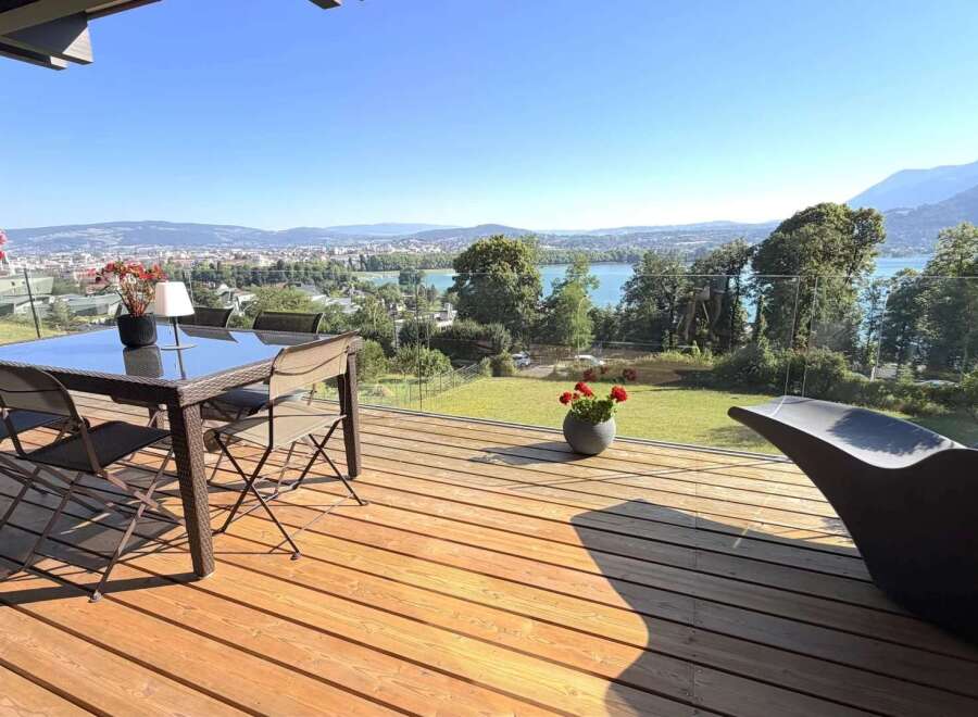 Enjoy breathtaking panoramic views from this stunning modern home's expansive deck, perfect for entertaining or relaxing.