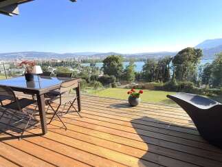 Enjoy breathtaking panoramic views from this stunning modern home's expansive deck, perfect for entertaining or relaxing.