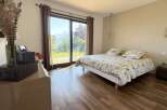 Experience breathtaking mountain and lake views from this serene bedroom, featuring a comfortable queen-size bed with a nature-inspired duvet.