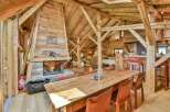 Experience rustic luxury in this stunning chalet! Featuring a cozy fireplace, exposed wooden beams, and a spacious dining area, this property offers a warm and inviting atmosphere.