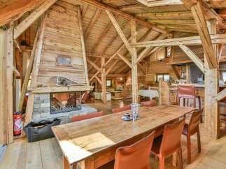 Experience rustic luxury in this stunning chalet! Featuring a cozy fireplace, exposed wooden beams, and a spacious dining area, this property offers a warm and inviting atmosphere.