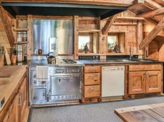Step into the heart of this rustic kitchen, where charm meets functionality.