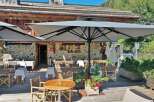 Experience the charm of this stunning restaurant with its inviting outdoor seating area.
