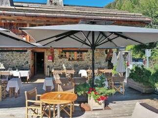 Experience the charm of this stunning restaurant with its inviting outdoor seating area.