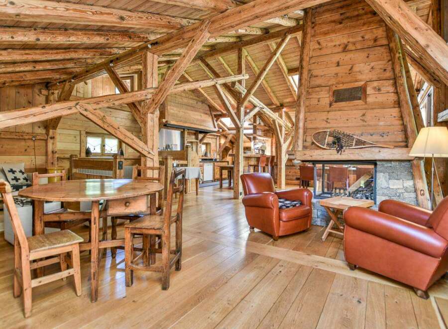 Experience rustic charm in this stunning property featuring exposed wooden beams and a cozy fireplace.