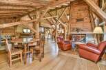 Experience rustic charm in this stunning property featuring exposed wooden beams and a cozy fireplace.