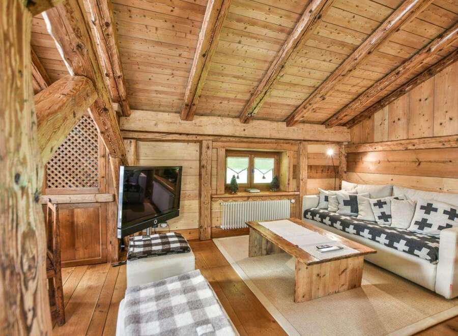 Experience the charm of this cozy cabin retreat, featuring a rustic wooden interior and a warm, inviting atmosphere.