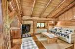 Experience the charm of this cozy cabin retreat, featuring a rustic wooden interior and a warm, inviting atmosphere.
