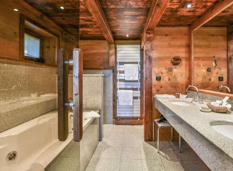 Experience luxury in this stunning bathroom featuring a beautiful wooden ceiling and walls, creating a warm and inviting atmosphere.