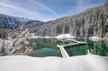 Experience the serenity of this stunning lakeside property, nestled amidst snow-covered mountains and evergreen forests.
