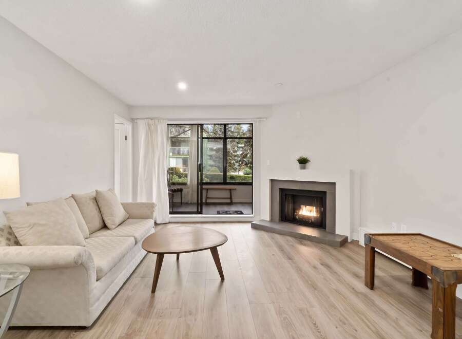 Step into this inviting living space, featuring a cozy fireplace and abundant natural light.